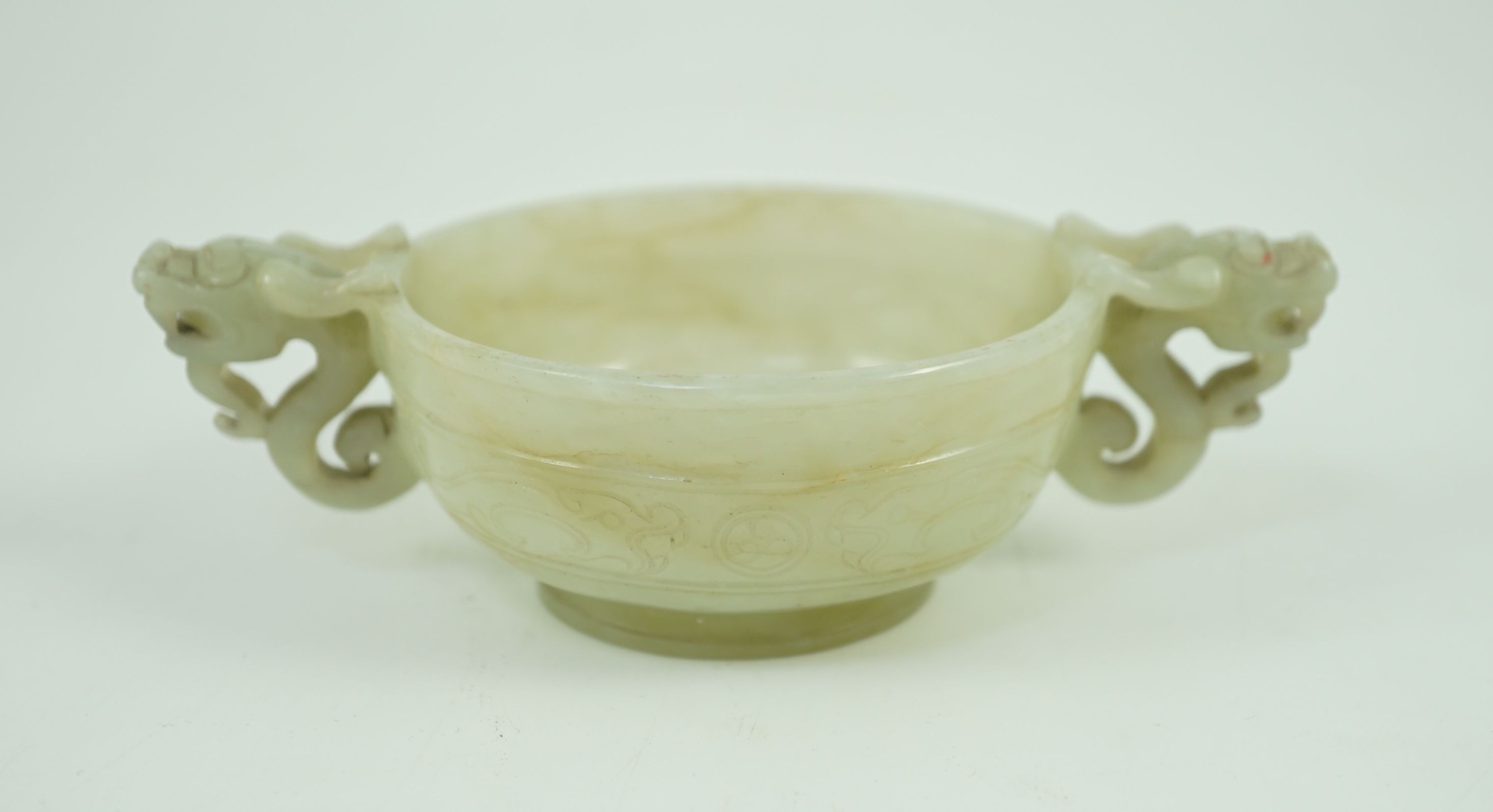 A Chinese pale celadon jade two handled ‘chilong’ cup, 17th/18th century, 13.2cm wide